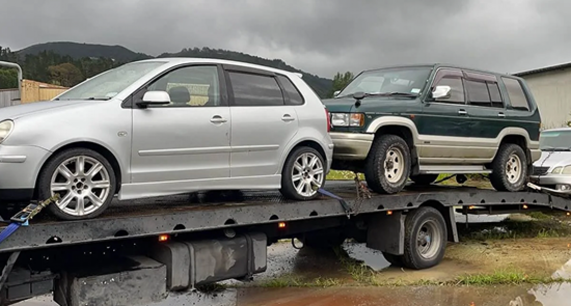 Free car removal in Levin – quick, safe, and reliable Tow truck transporting three scrap cars for removal in Levin